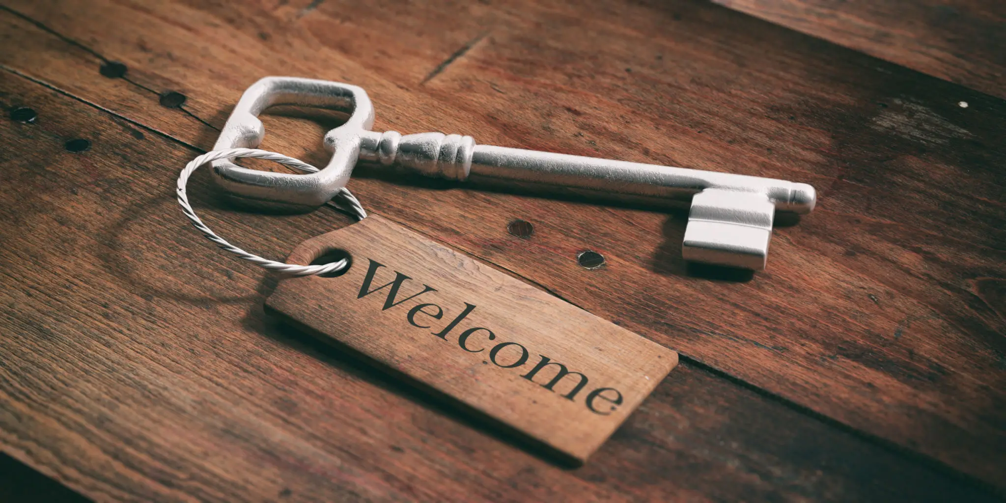 Silver key with a "Welcome" tag.
