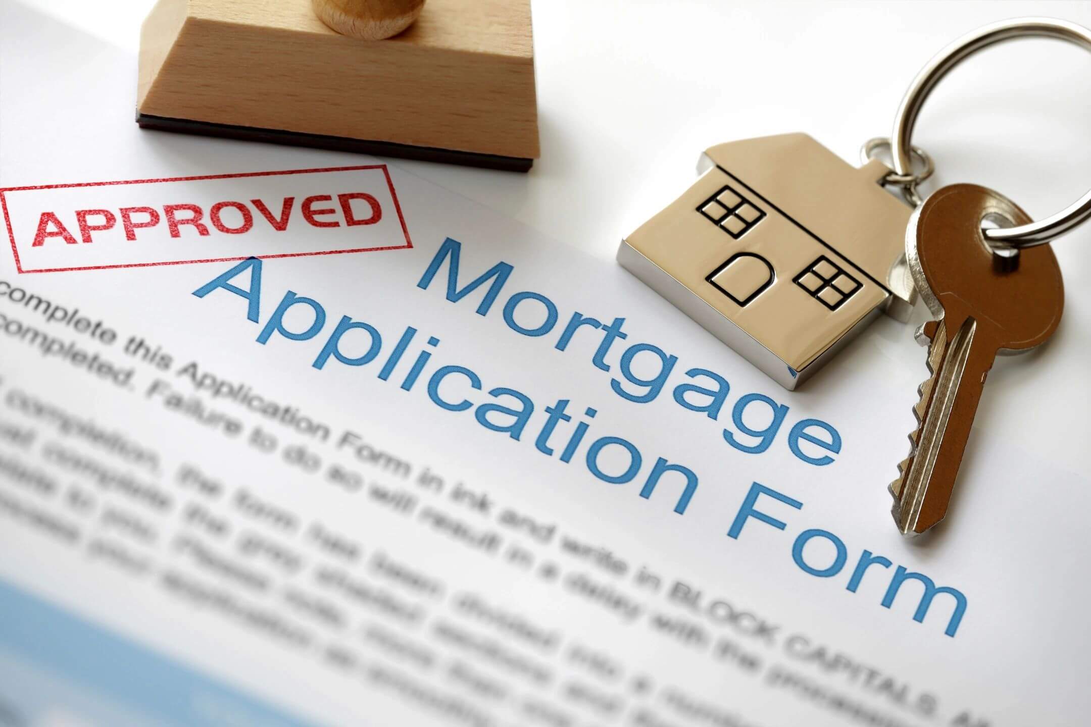 Approved mortgage application form with key.