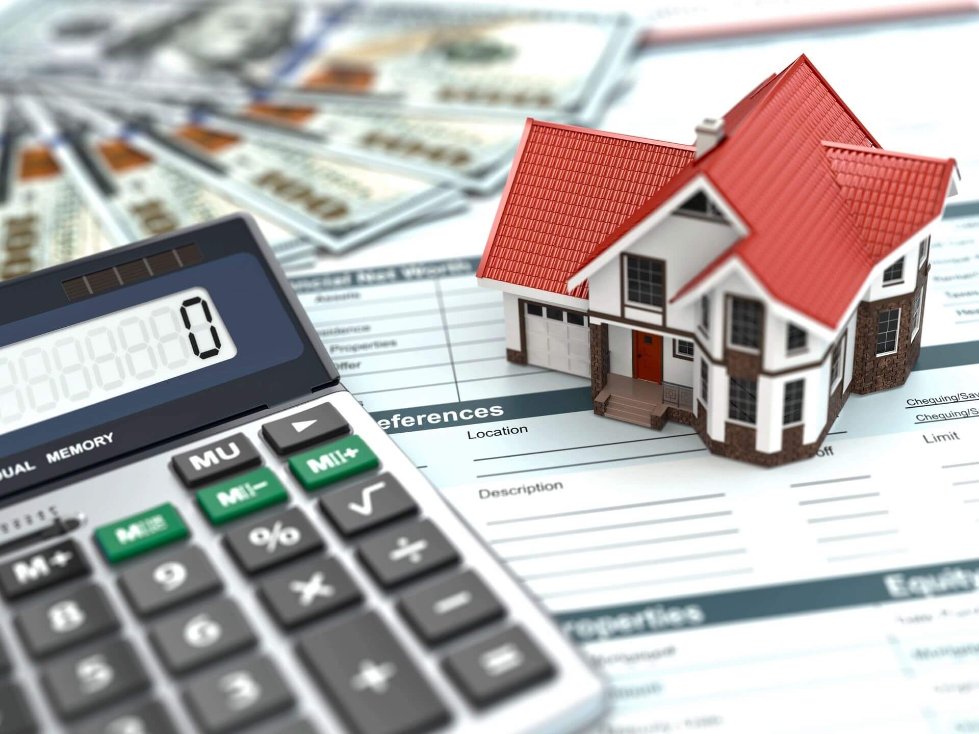 Calculator, house model, and financial documents.